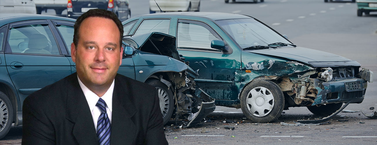 Picture of attorney Joseph I. Lipsky in front of a car accident scene